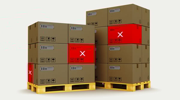 Cardboard boxes on a skid with some showing a red x to demonstrate defective parts ready to ship.