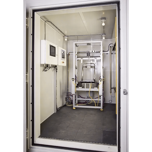 view into a sound booth with a part being tested and the test instrumentation on the left