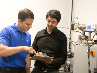 Two Sciemetric employees working on a test system installation.
