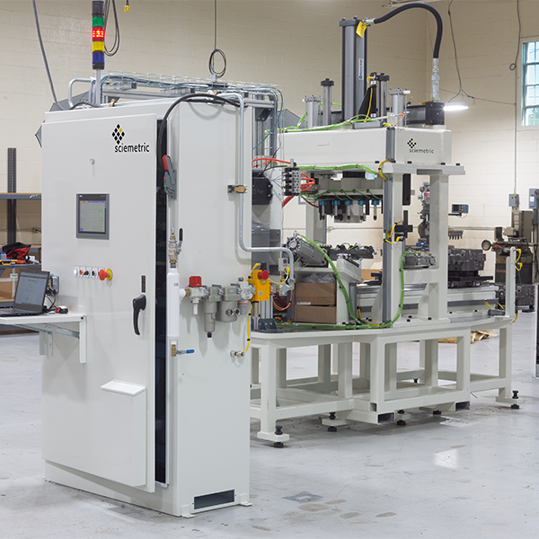 Leak test machine with status light in two parts, one with controller and the other with the part test automation