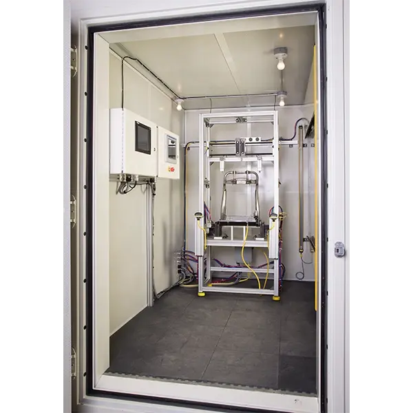 view into a sound booth with a part being tested and the test instrumentation on the left