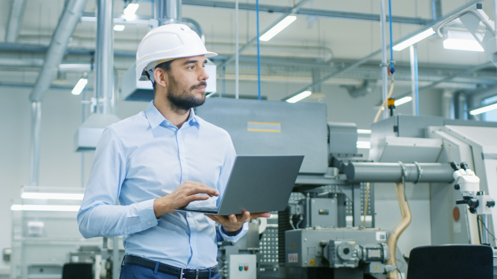 Engineer walking on the production line with laptop