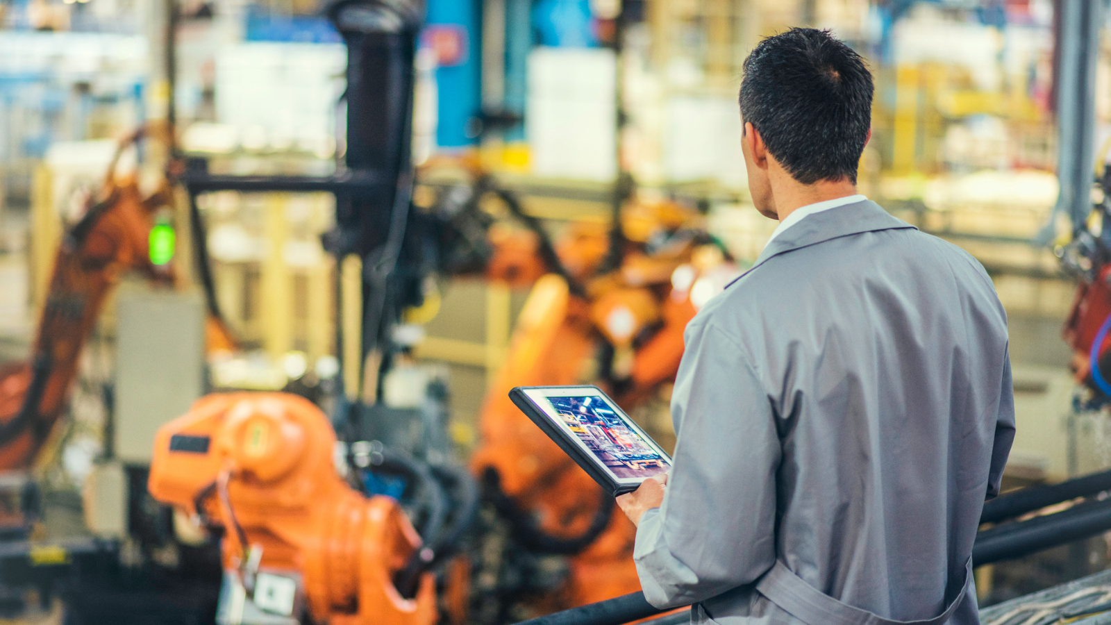 engineer looking over factory floor 