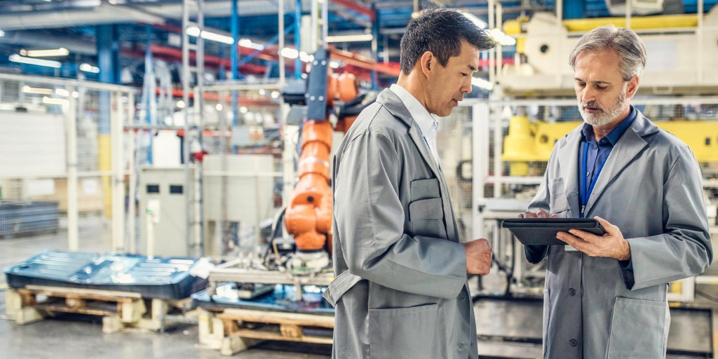 Two men in discussion on production line floor