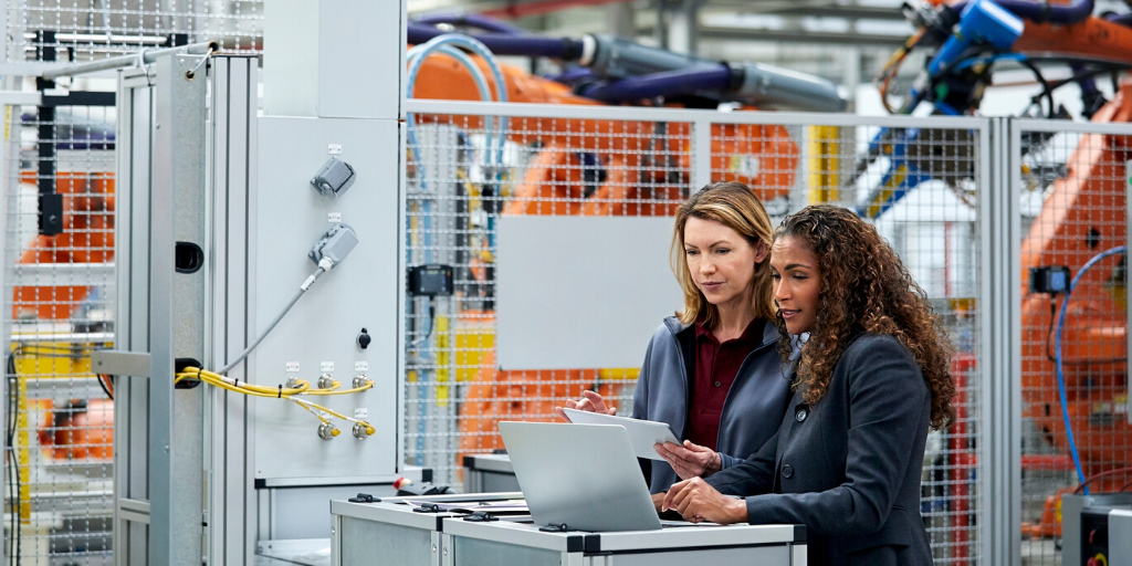 engineers looking at data on production line