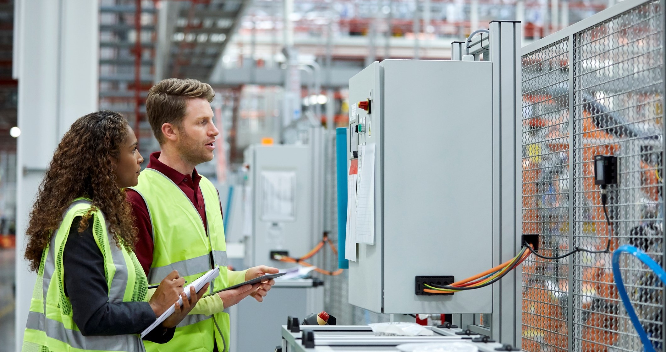 two operators looking at production line